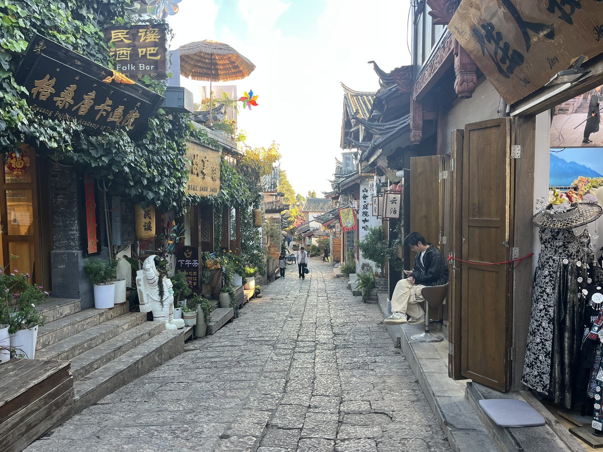 Traditional buildings and shops lining a narrow street in Lijiang