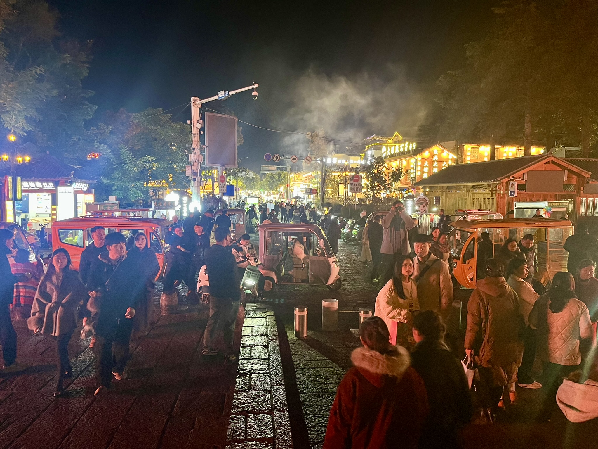 Night market scene with crowds and food stalls