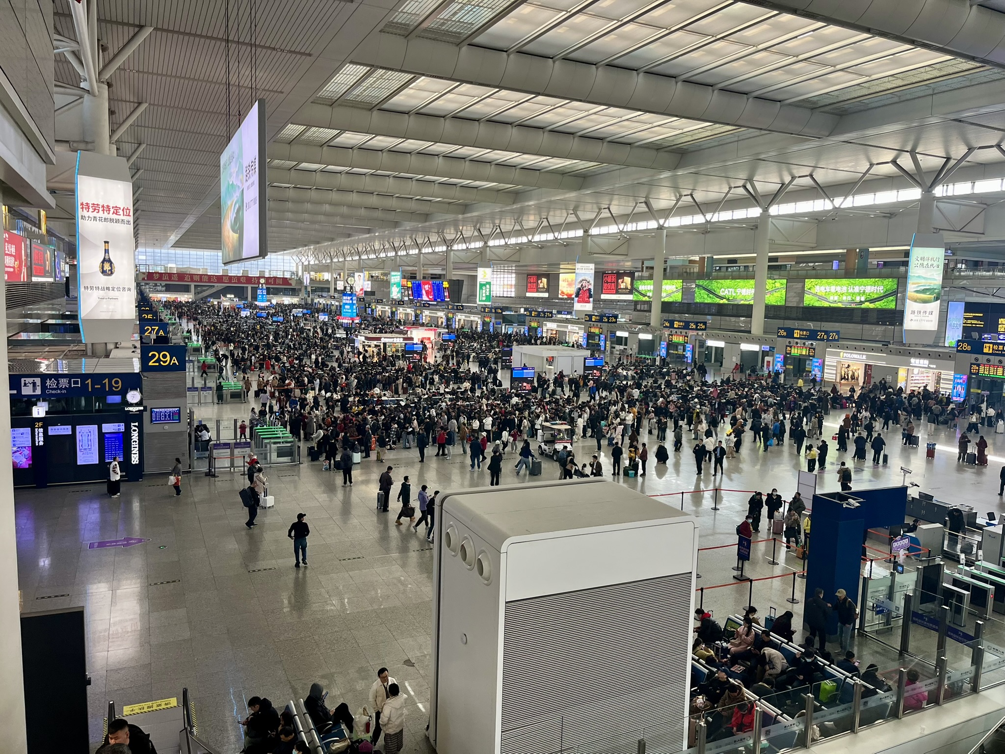 Massive train station filled with crowds of travelers