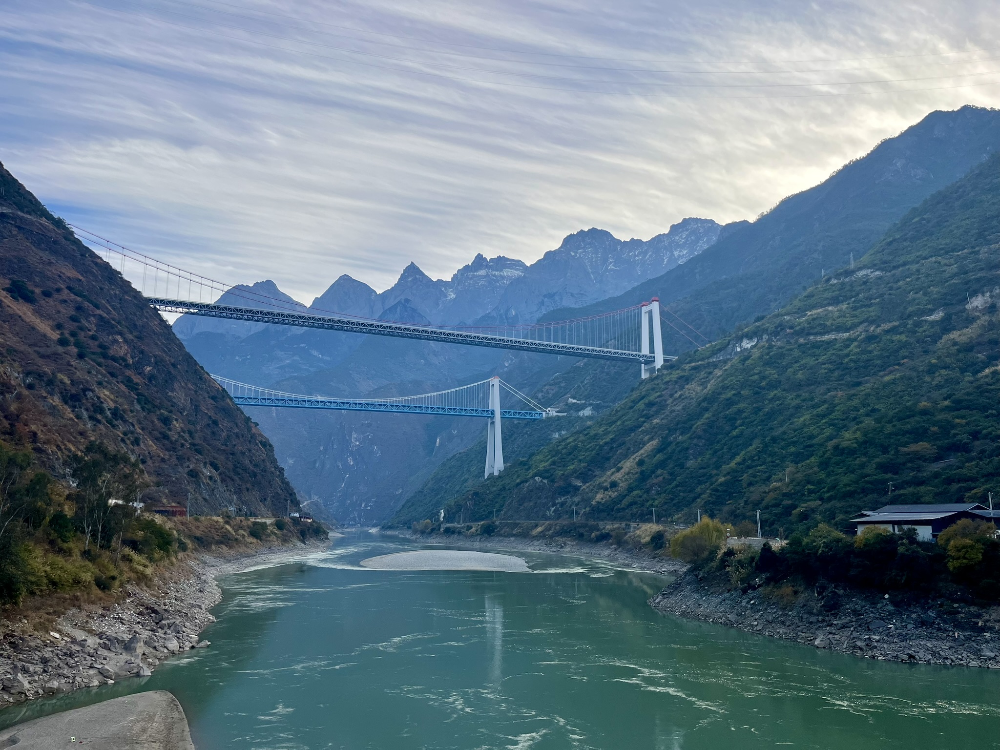 Suspension bridge spanning a river valley in Yunnan mountains